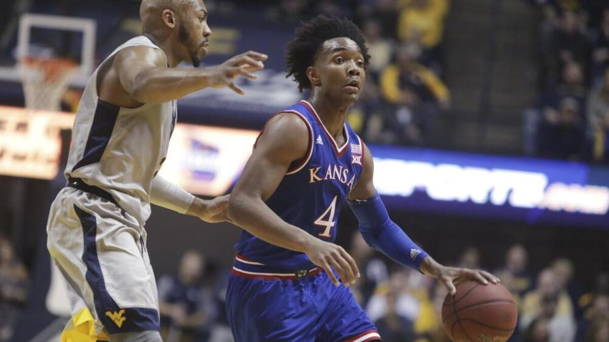 Devonte Graham (right) and Kansas won at West Virginia on Monday, and the Jayhawks now stand alone atop the Big 12 standings.