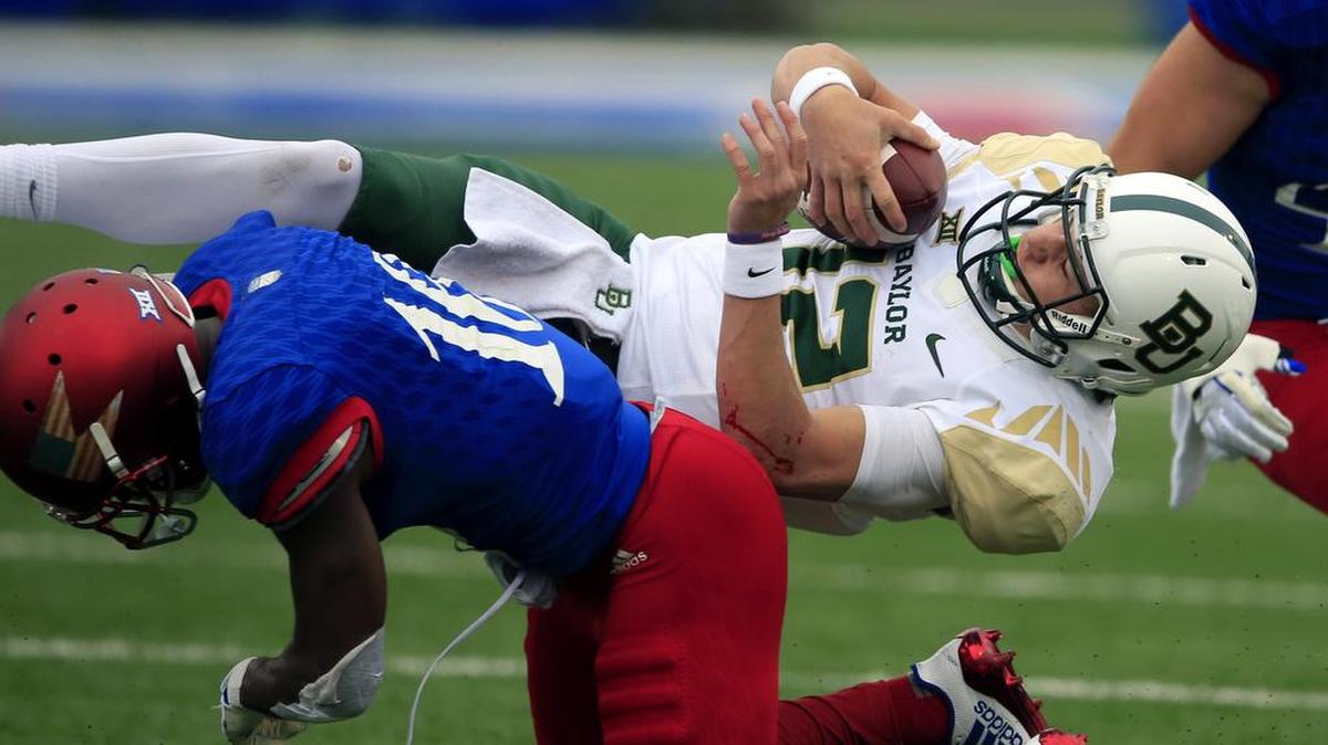 Baylor quarterback Charlie Brewer was upended by Kansas cornerback Kyle Mayberry on this play Saturday, but when Brewer was upright he passed for 315 yards and three touchdowns.