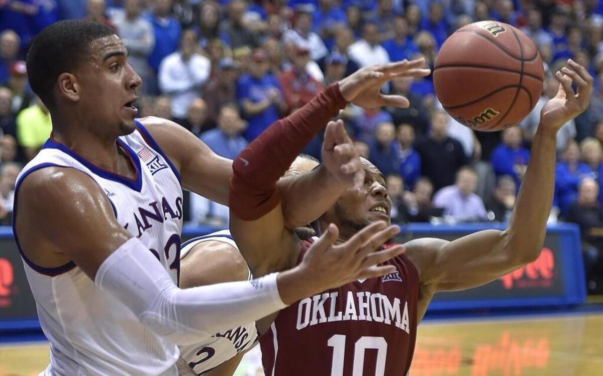 KU's Landen Lucas (left) battled OU's Jordan Woodard for a rebound late in the Jayhawks’ 109-106 triple overtime victory two weeks ago at Allen Fieldhouse.