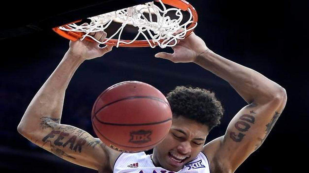 
KU’s Kelly Oubre threw down a two-handed dunk late in the Jayhawks’ 64-59 win over TCU during the Big 12 Tournament at the Sprint Center. The “fear” tattooed on his right arm is accompanied by scenes of his hometown of New Orleans, while the “God” on his left is accompanied by religious scenes.
