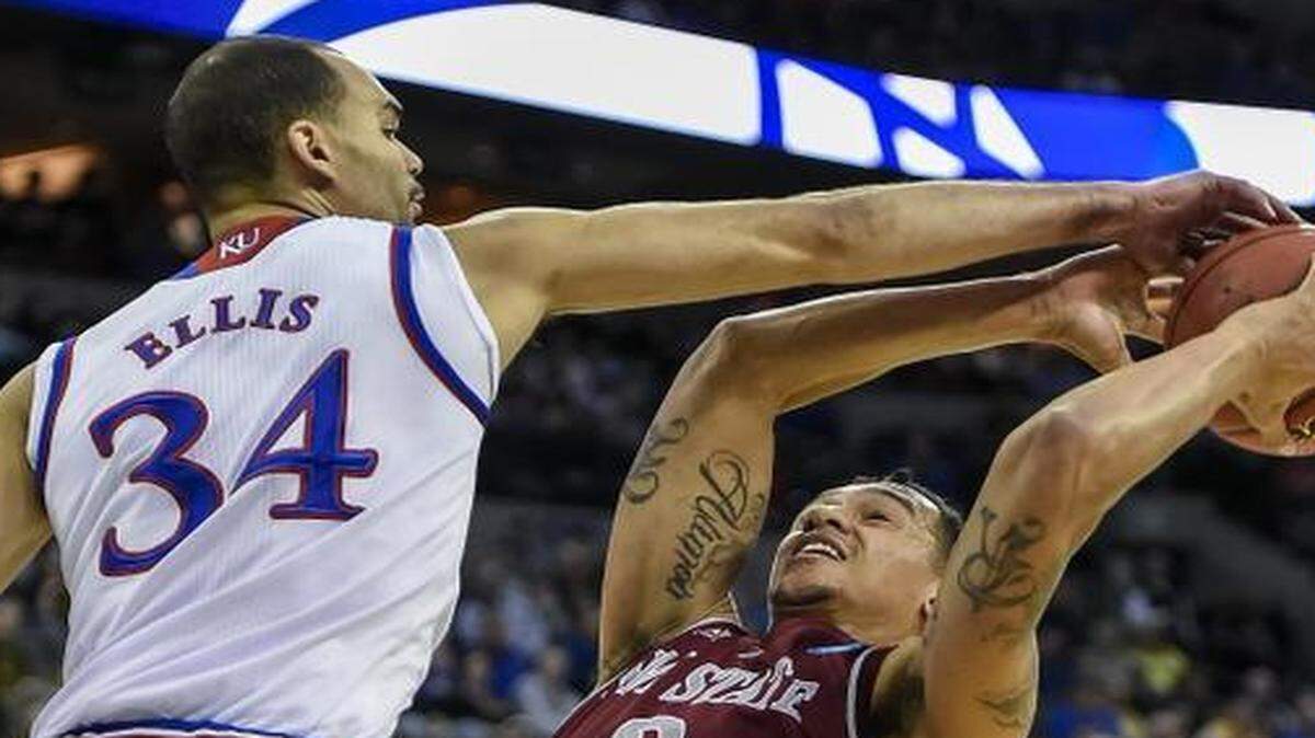 
KU forward Perry Ellis (left) blocked New Mexico State’s Remi Barry’s path to the basket in Friday’s game.
