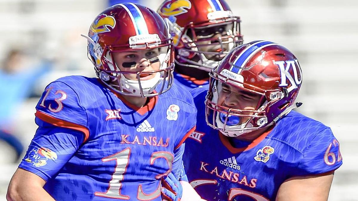 Kansas quarterback Ryan Willis (left) was congratulated by offensive lineman D’Andre Banks after Willis scored a touchdown in the second half Saturday against TCU at Memorial Stadium in Lawrence.