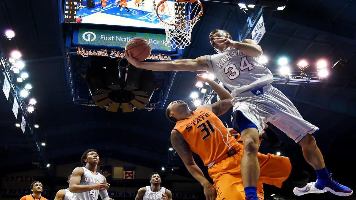KU's Perry Ellis (34) sailed by OSU's Chris Olivier for the reverse during the second half of Monday night's game at Allen Fieldhouse. KU beat Oklahoma State, 94-67.