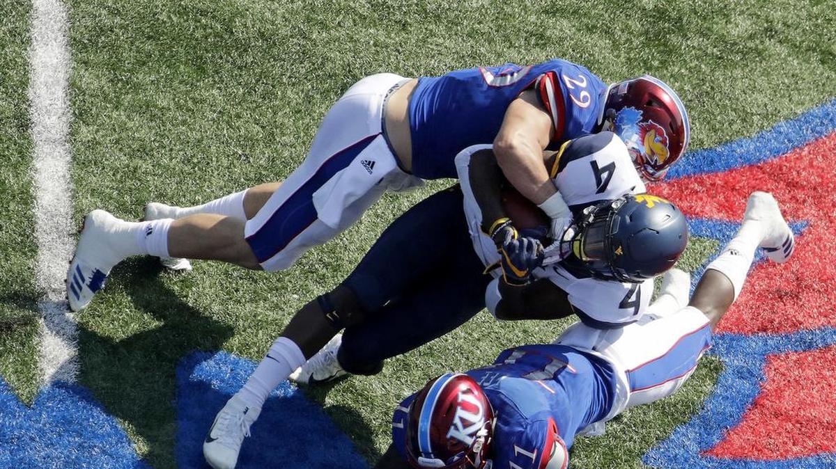 The KU football team is having a rough season to be sure, but linebacker Joe Dineen (top) has been doing his job, and then some.