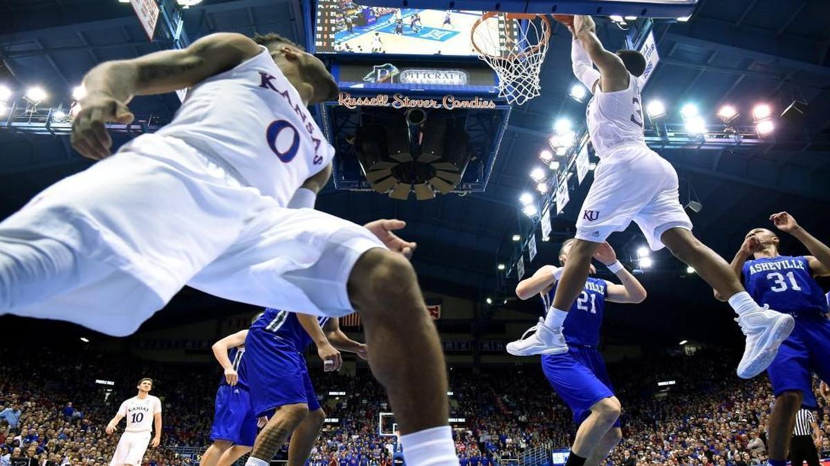 KU’s Landen Lucas took a pass from teammate Frank Mason (0) and slammed home a dunk in the second half of the No. 5 Jayhawks’ 95-57 win over UNC-Asheville on Friday night at Allen Fieldhouse in Lawrence.