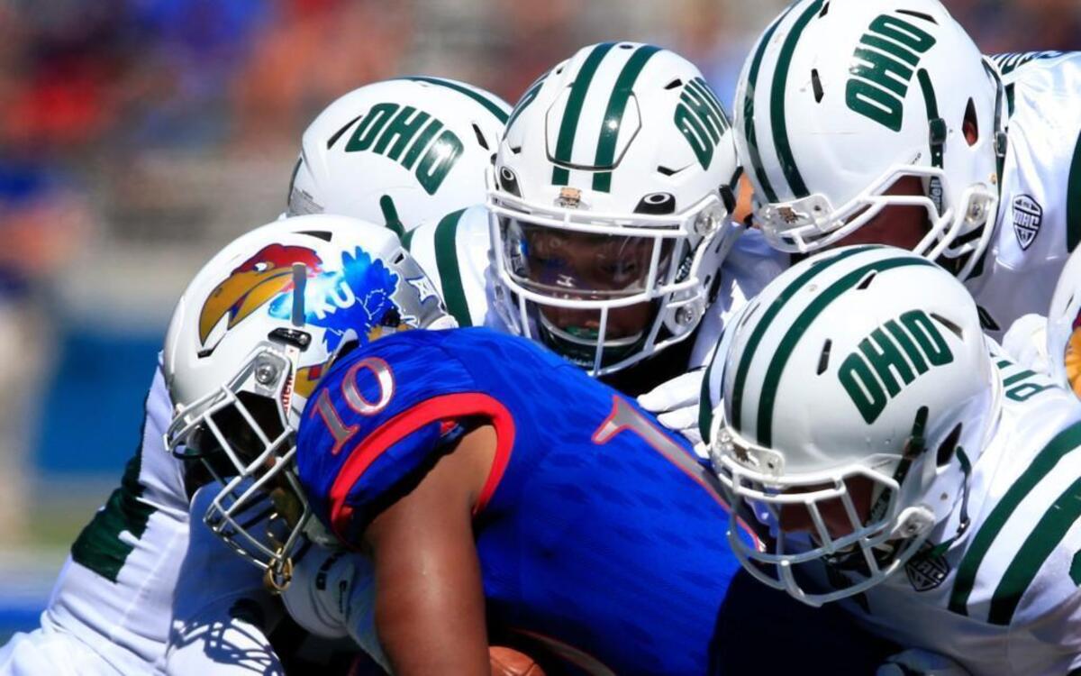 Kansas running back Khalil Herbert (10) ran into a wall of Ohio defenders in the first half Saturday in Lawrence. The Bobcats beat the Jayhawks 37-21.