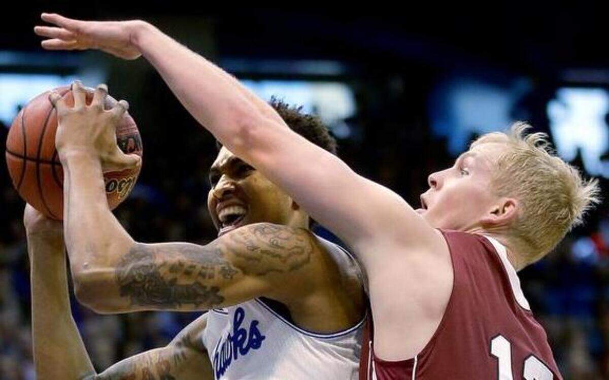 
Kansas’ Kelly Oubre (left) shot under pressure from Lafayette’s Seth Hinrichs in the first half Saturday at Allen Fieldhouse in Lawrence. The No. 10 Jayhawks won the game 96-69.

