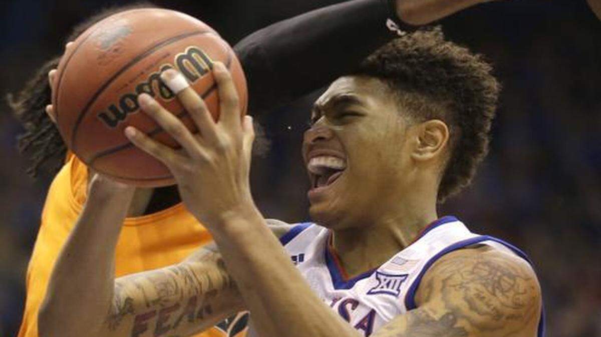 
Kansas guard Kelly Oubre Jr. (12) was fouled by Oklahoma State center Anthony Allen Jr. (left) during the first half on Jan. 13 at Allen Fieldhouse in Lawrence.
