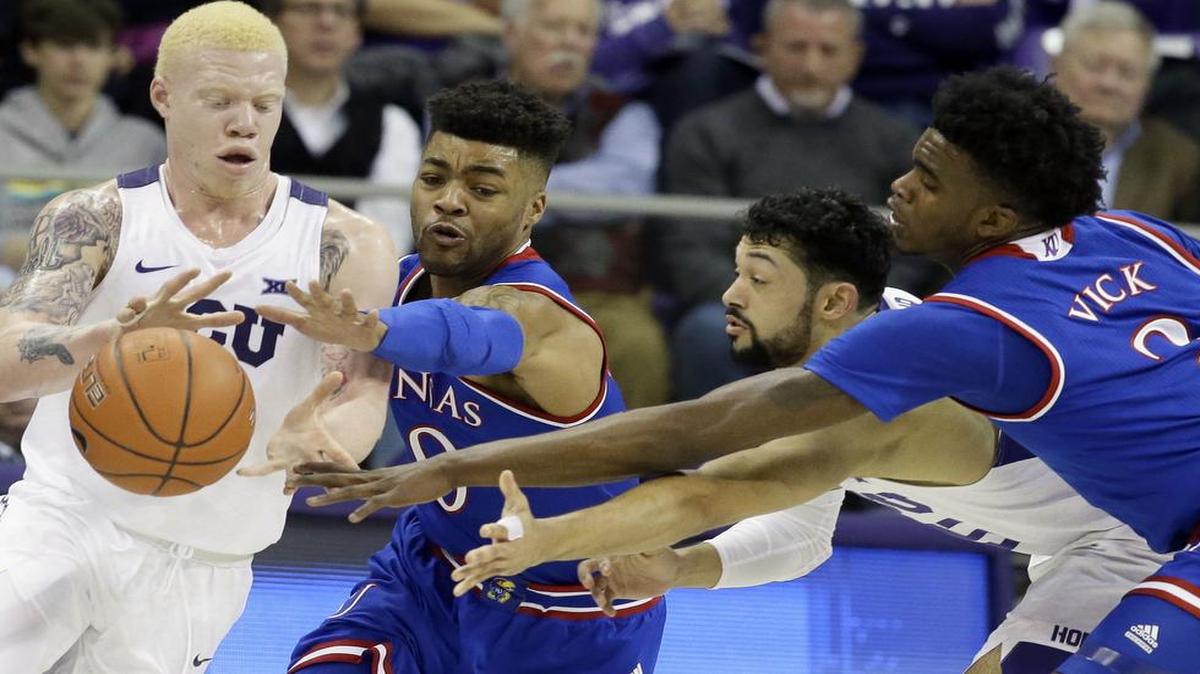 TCU guards Jaylen Fisher, left, Alex Robinson, second from right, along with Kansas guards Frank Mason III (0) and Lagerald Vick (2) all reach of the ball during the first half of a game on Friday, Dec. 30, 2016, in Fort Worth, Texas.