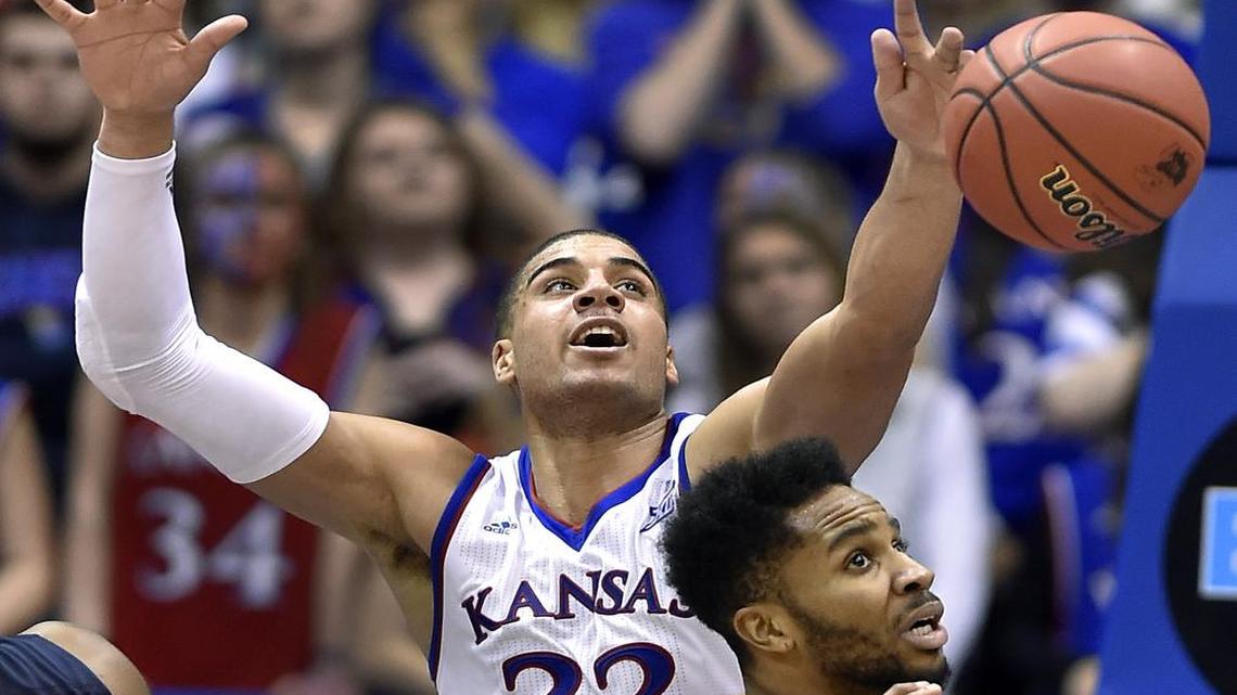 KU's Landen Lucas (rear) who had four blocks Tuesday night rejects this shot by West Virginia's Tarik Phillip during the second half of Tuesday night's game at Allen Fieldhouse. KU won, 75-65.