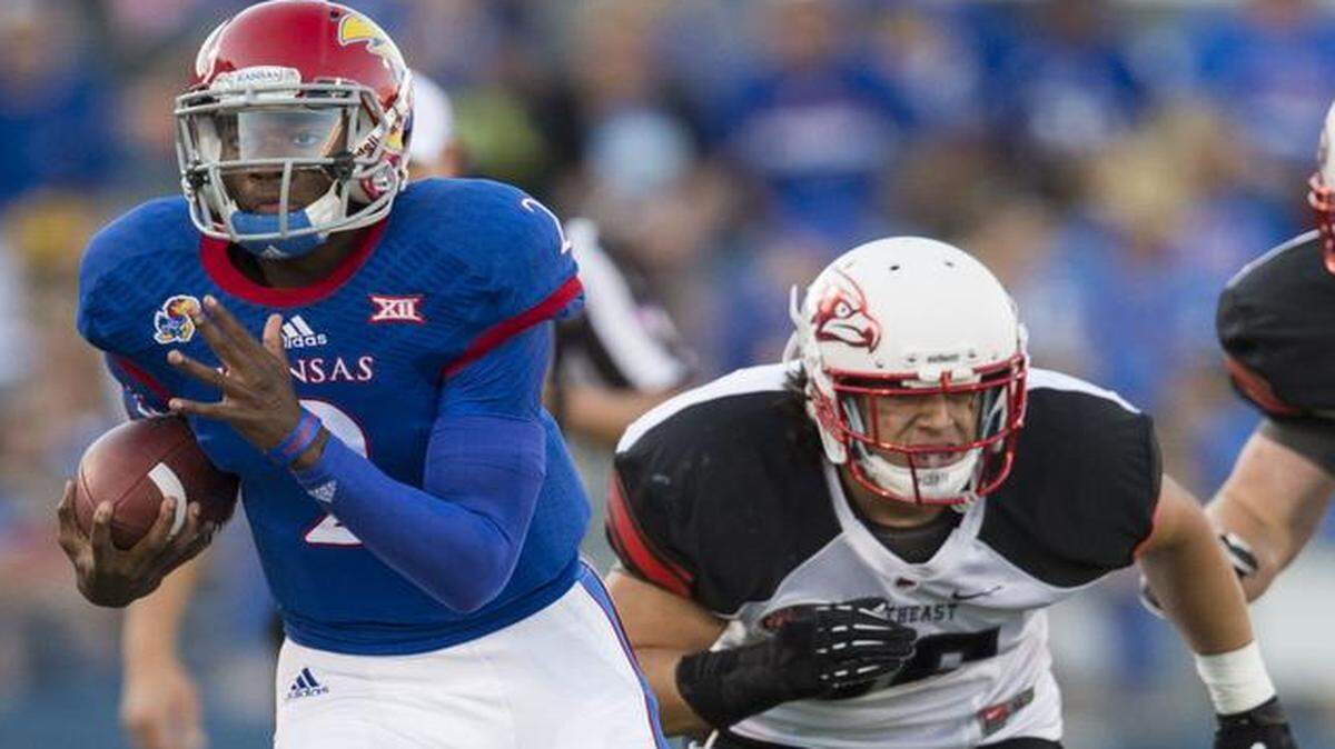 
Kansas Jayhawks quarterback Montell Cozart ran past Southeast Missouri State safety Eriq Moore in last week’s game.
