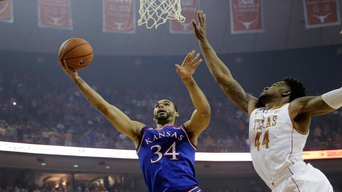 Kansas forward Perry Ellis (34) drives to the basket past Texas center Prince Ibeh (44) during Monday’s Big 12 basketball game in Austin.