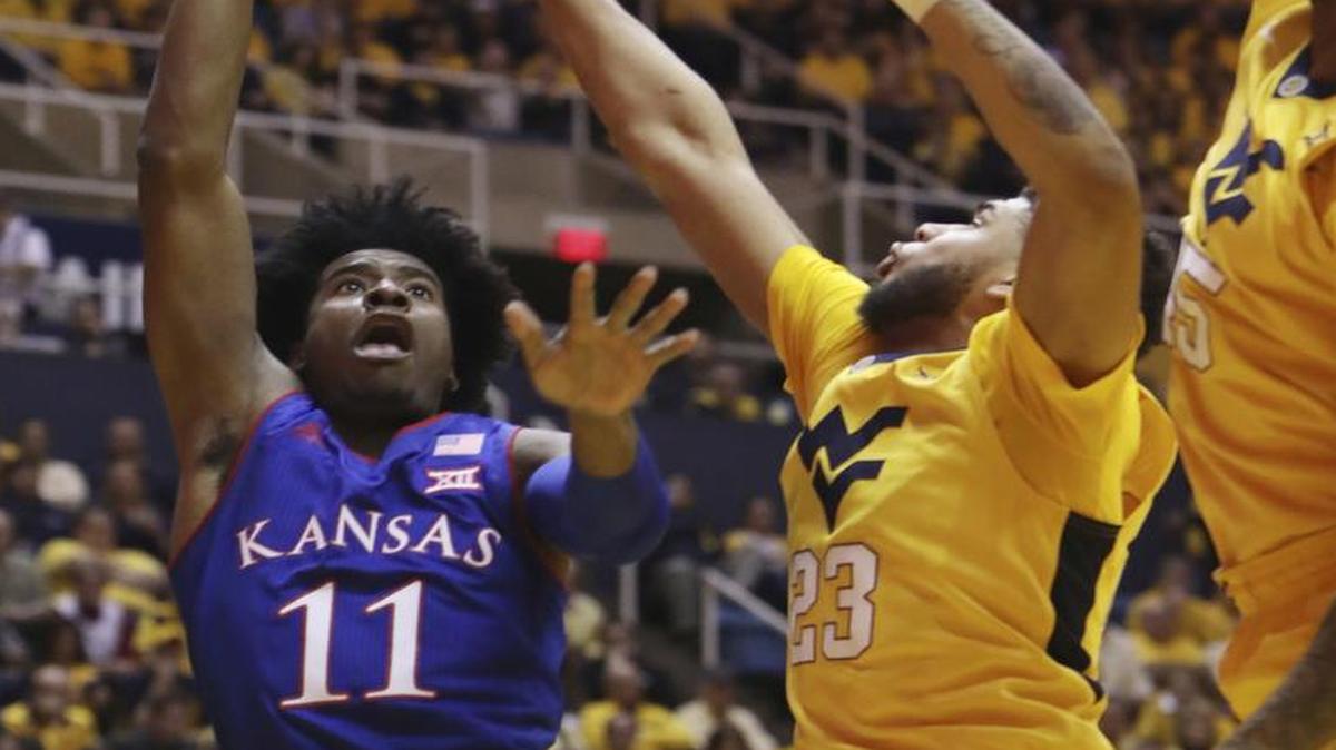 KU’s Josh Jackson took a shot as West Virginia forward Esa Ahmad attempted to block him during the first half of a game on Tuesday, Jan. 24, 2017, in Morgantown, W.Va.