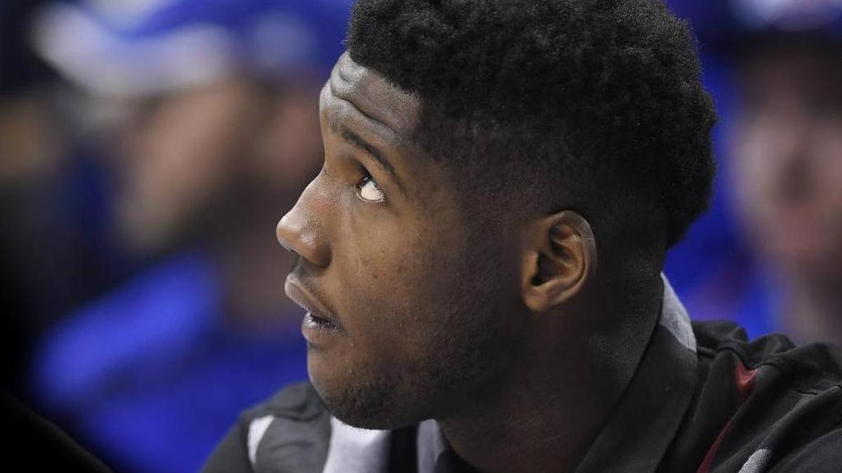 Carlton Bragg sits on the bench during a game last season.