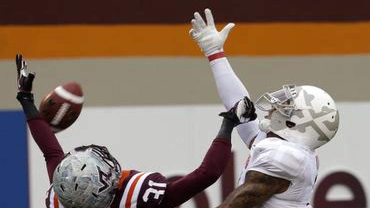 
Former Maryland wide receiver Nigel King (right) went up for a pass against Virginia Tech cornerback Brandon Facyson on Nov. 16, 2013. King graduated from Maryland last week and will join the Jayhawks this season.
