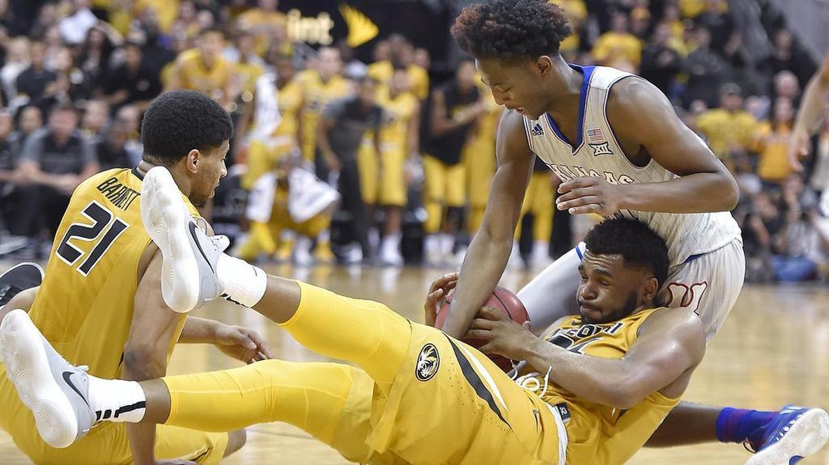 KU freshman Marcus Garrett (right) tried to get the ball away from MU’s Kevin Puryear in an exhibition game Oct. 22 at the Sprint Center.