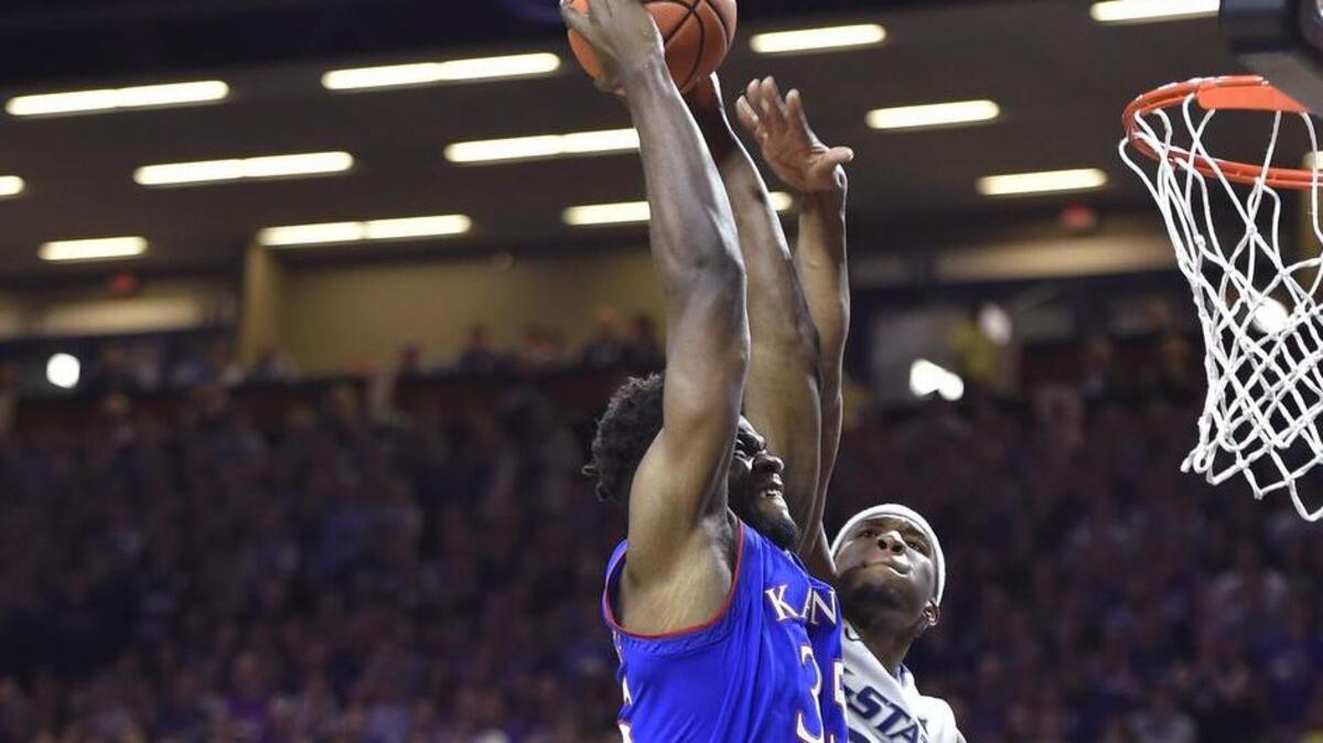 KU’s Udoka Azubuike went up for a dunk against K-State’s Dean Wade (left) and Xavier Sneed in the second half of Monday night’s game at Bramlage Coliseum in Manhattan, Kan. The Jayhawks beat the Wildcats 70-56.