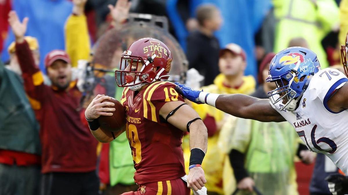 Iowa State wide receiver Trever Ryen (19) ran from Kansas offensive lineman Chris Hughes while returning a punt 68 yards for a touchdown during the first half of an NCAA college football game, Saturday, Oct. 14, 2017, in Ames, Iowa.