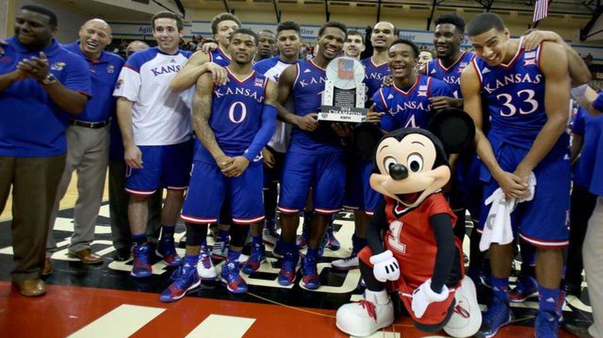 
The No. 11-ranked Kansas Jayhawks posed with the trophy and Mickey Mouse after beating No. 20 Michigan State 61-56 to win the Orlando Classic Championship on Sunday in Lake Buena Vista, Fla.
