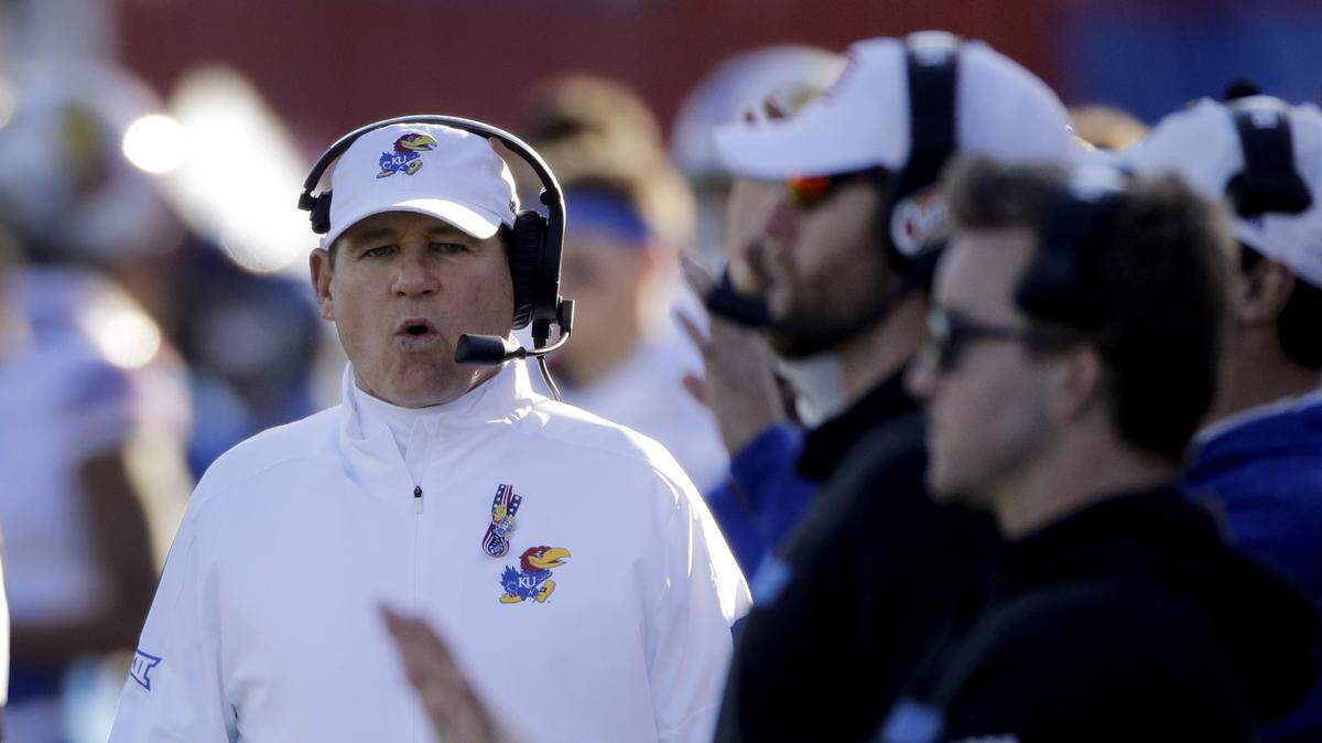 Kansas head coach Les Miles (left) watches from the sideline during the first half of an NCAA college football game against Baylor, Saturday, Nov. 30, 2019, in Lawrence.