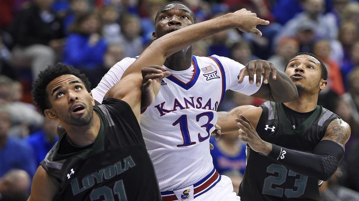 KU’s Cheick Diallo battled Loyola’s Jarred Jones (left) and Tyler Hubbard for a rebound in the first half Tuesday night at Allen Fieldhouse in Lawrence.