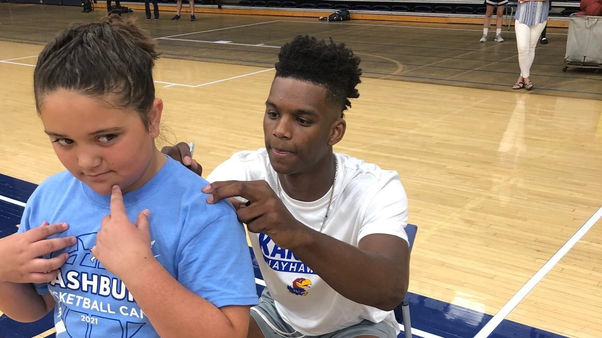 Kansas freshman forward KJ Adams signs a shirt for a camper at Washburn basketball camp on Wednesday, June 9, 2021.