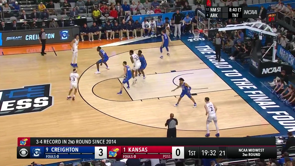 Creighton’s Ryan Hawkins (44) plays off KU guard Dajuan Harris.