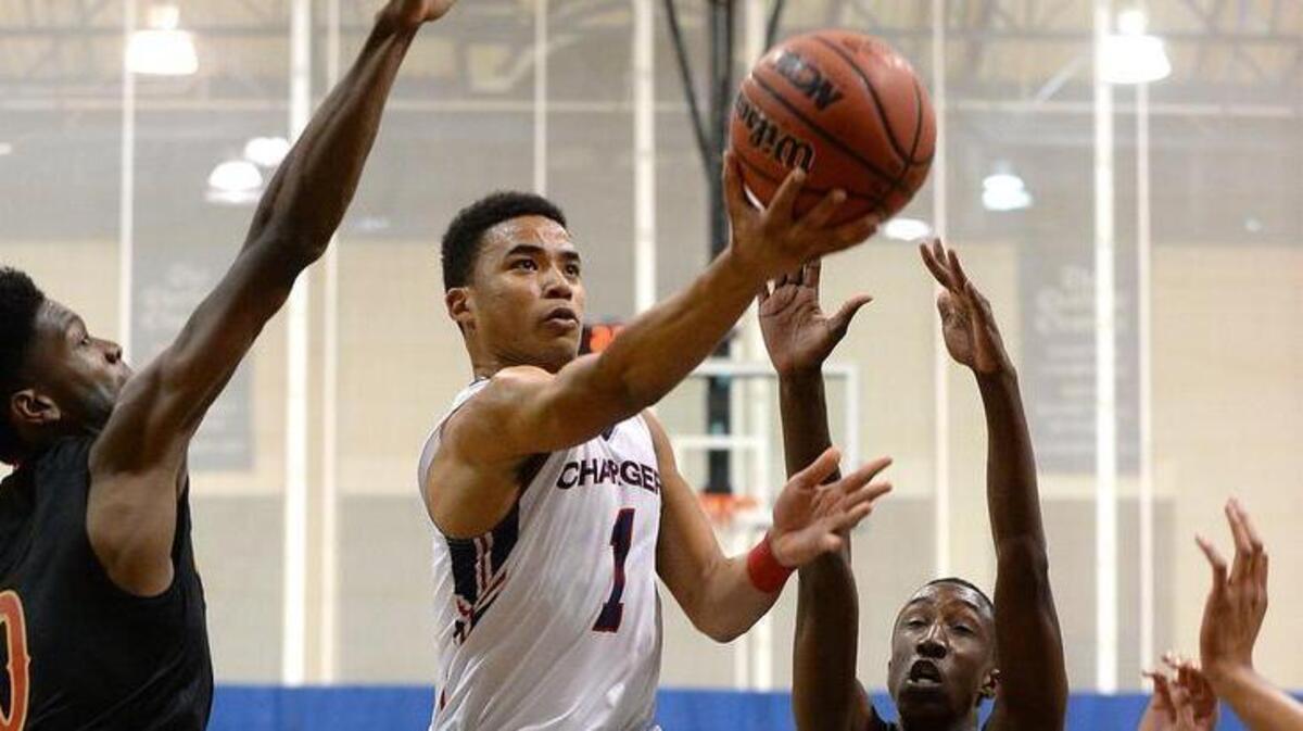 Providence Day's Devon Dotson, center, drives to the basket past Wesleyan Christian Academy's Shawn Walker Jr., right, during first half action on Tuesday, Nov. 15, 2016, at Providence Day School in Charlotte, NC.