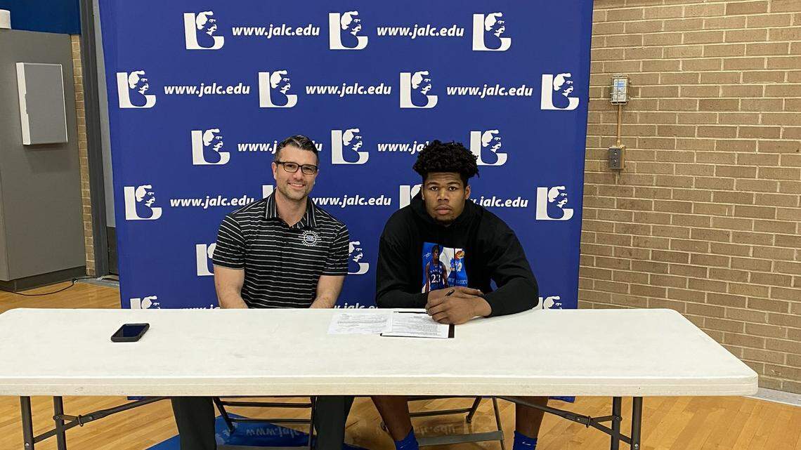 Sydney Curry, right, is pictured on signing day when he initially committed to Kansas men’s basketball in April. Curry reopened his recruitment Wednesday.