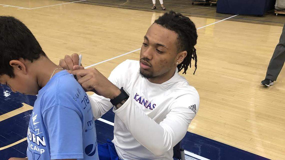 Kansas freshman guard Bobby Pettiford signs a shirt for a camper at Washburn basketball camp on Wednesday, June 9, 2021, in Topeka.