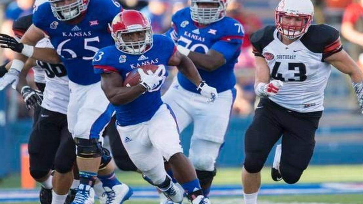 
Kansas running back De'Andre Mann (23) broke through a hole against Southeast Missouri State football game during their Sept. 6 in Lawrence.
