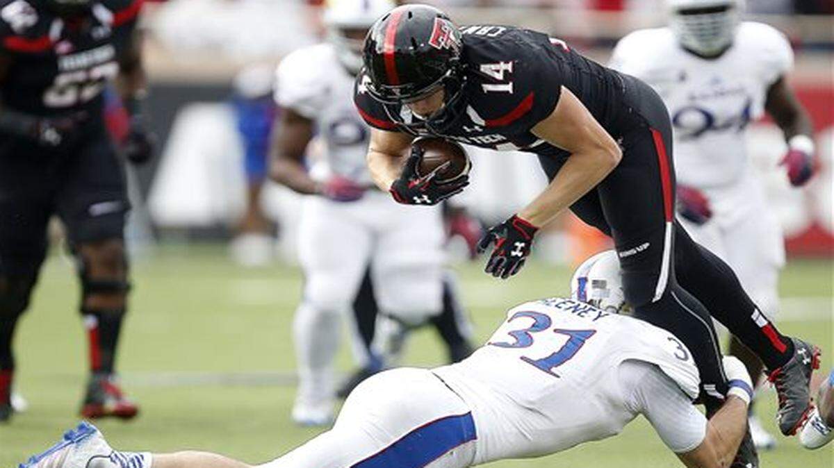 
Kansas linebacker Ben Heeney tackled Texas Tech’s Dylan Cantrell, one of his 21 tackles in Saturday’s game.


