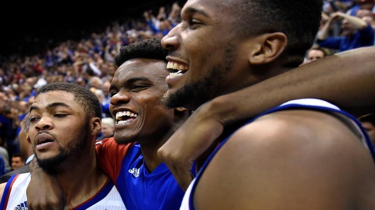 KU point guard Frank Mason (left) spent Monday night chasing Oklahoma’s Buddy Hield around the court, then appeared spent after the game while celebrating with teammates Lagerald Vick (center) and Wayne Selden.