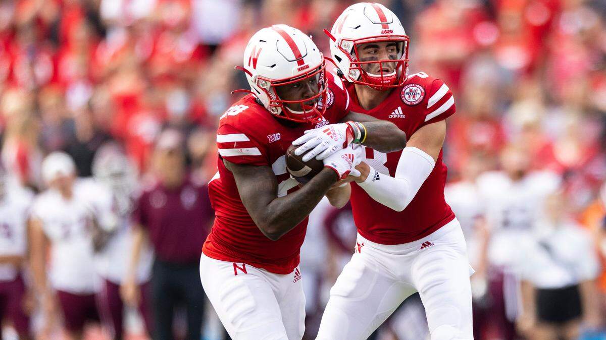 Nebraska quarterback Logan Smothers, right, hands off the ball to Sevion Morrison (28) against Fordham during the second half of a game Saturday, Sept. 4, 2021, at Memorial Stadium in Lincoln, Neb.