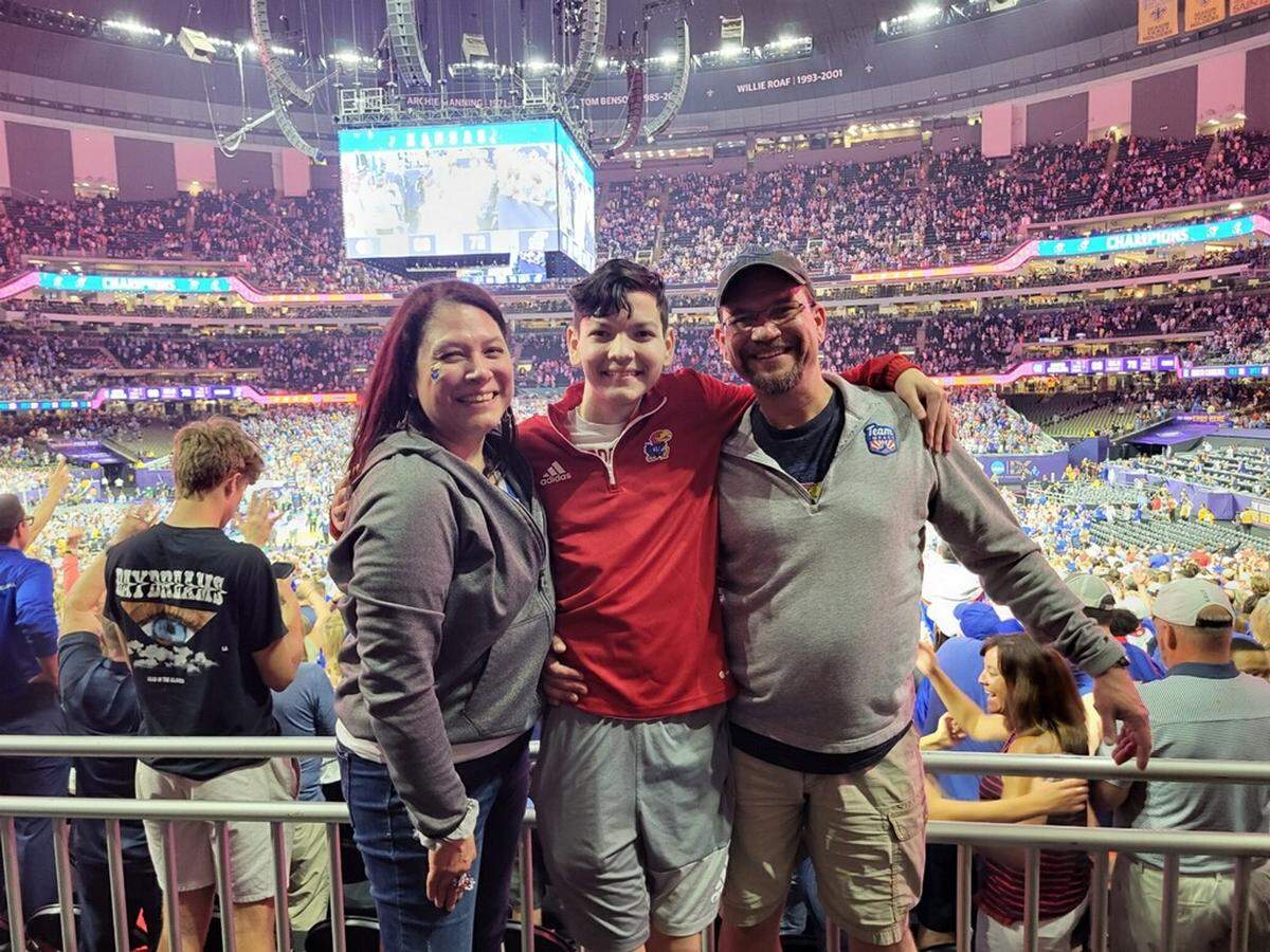 JP Bemberger of Lenexa, Kansas, center, smiles with mother Michelle and father Tom at the 2022 Final Four in New Orleans.