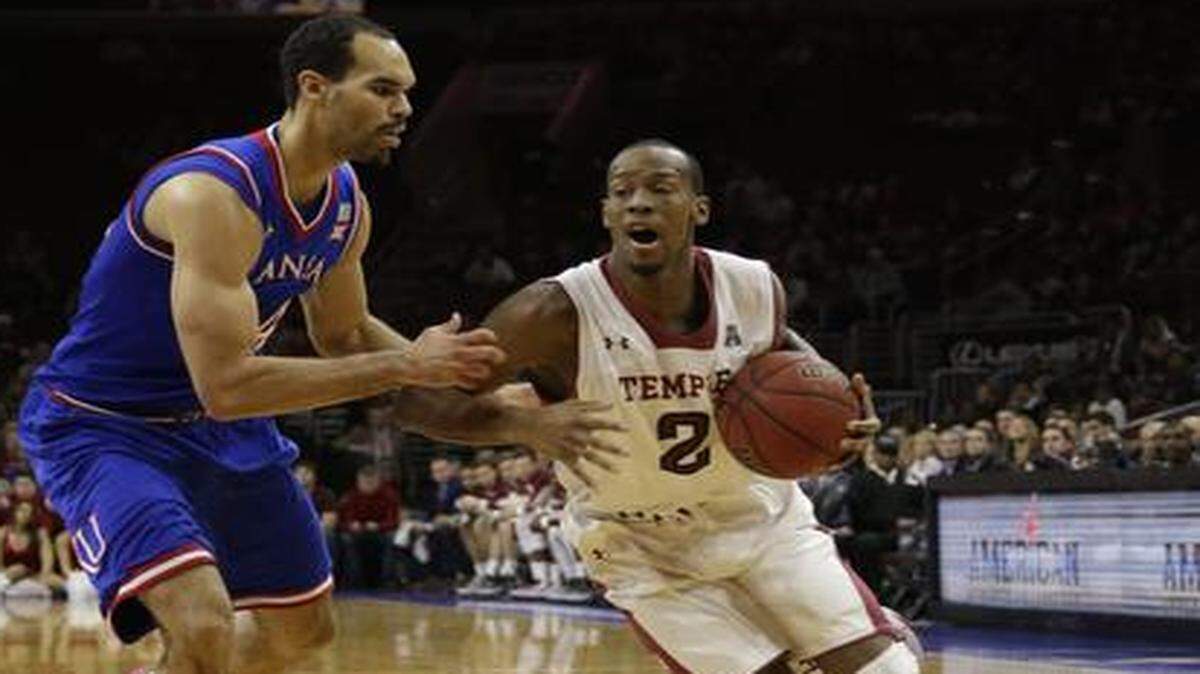 
Temple’s Will Cummings drove by Kansas’ Perry Ellis on Dec. 22 in Philiadelphia.


