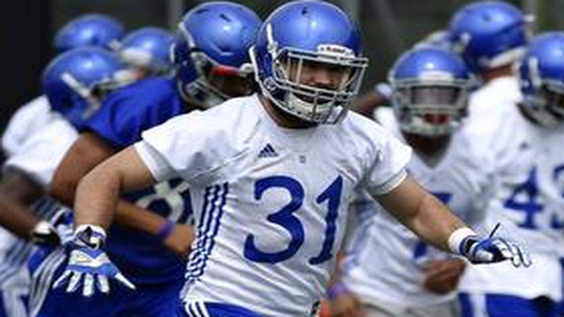 
KU’s football team gets ready for the season on the practice field near Memorial Stadium Friday, Aug. 8, 2014. Linebacker Ben Heeney (31) and teammates do drills.
