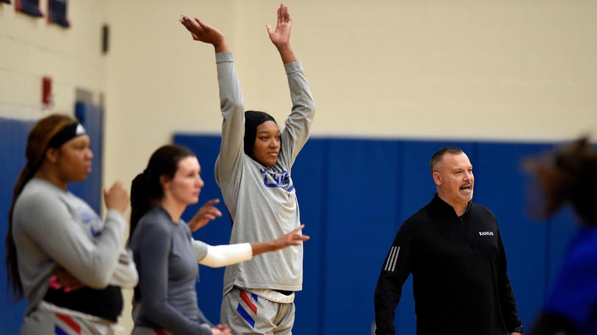 KU women’s basketball coach Brandon Schneider, right, and 6-foot-6 Taiyanna Jackson, left, have helped the Jayhawks to a 19-6 record this season.