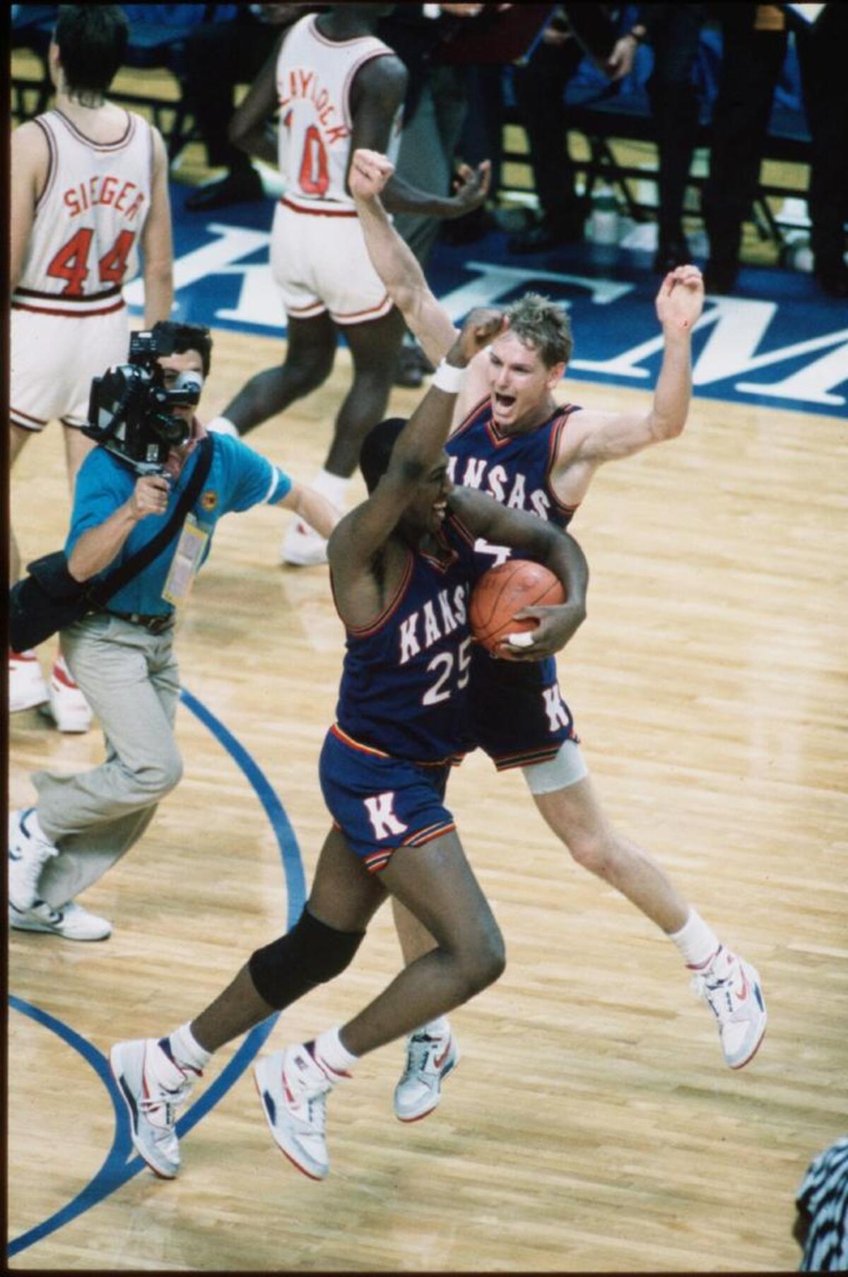 KU’s Danny Manning, with ball, Chris Piper and the rest of the Jayhawks celebrated with abandon after the final seconds ticked away at Kemper Arena.