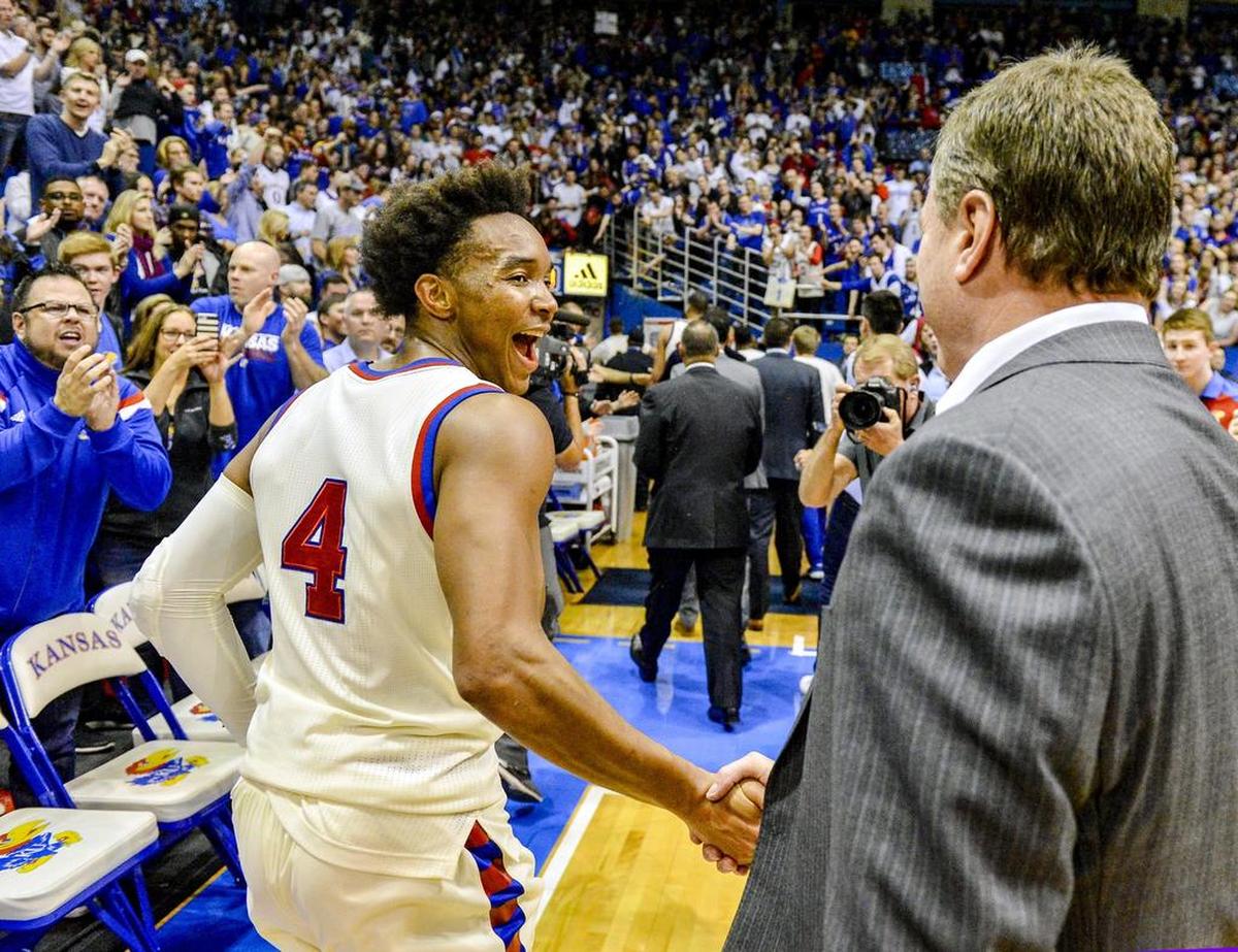 Kansas coach Bill Self congratulated Devonte’ Graham (4) on Monday at Allen Fieldhouse in Lawrence. KU defeated West Virginia 84-80 in overtime.