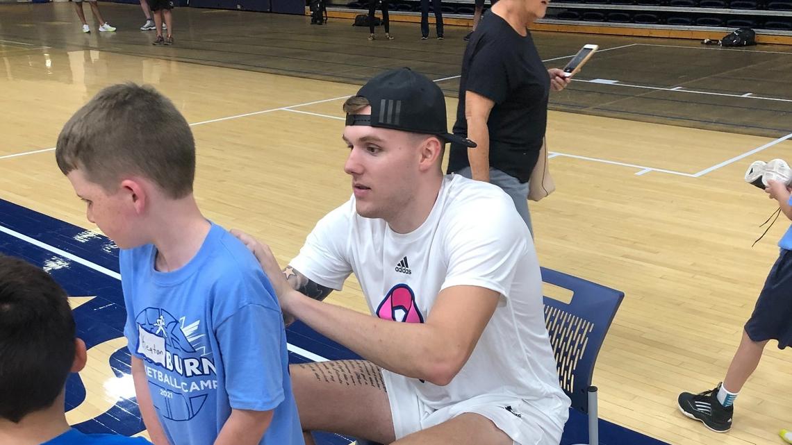 Kansas super-senior forward Cam Martin signs autographs at Washburn’s basketball camp in Topeka.
