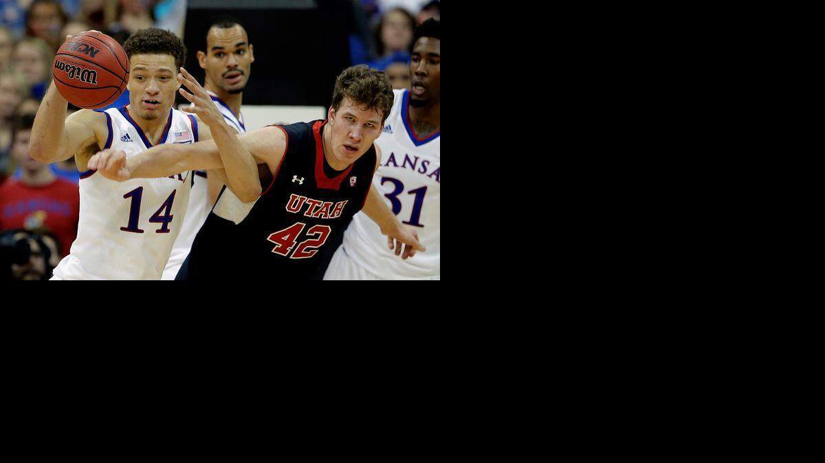 
Kansas’ Brannen Greene (14) and Utah’s Jakob Poeltl chased a loose ball in the first half Saturday at the Sprint Center in Kansas City.
