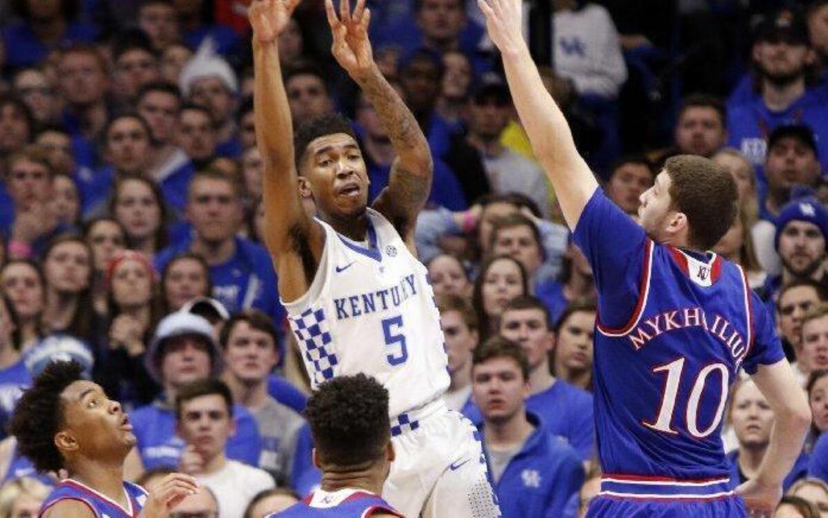 Kentucky’s Malik Monk passed the ball while surrounded by Kansas’ Devonte' Graham (left), Frank Mason III (center) and Svi Mykhailiuk in Saturday’s game at Rupp Arena in Lexington, Ky.