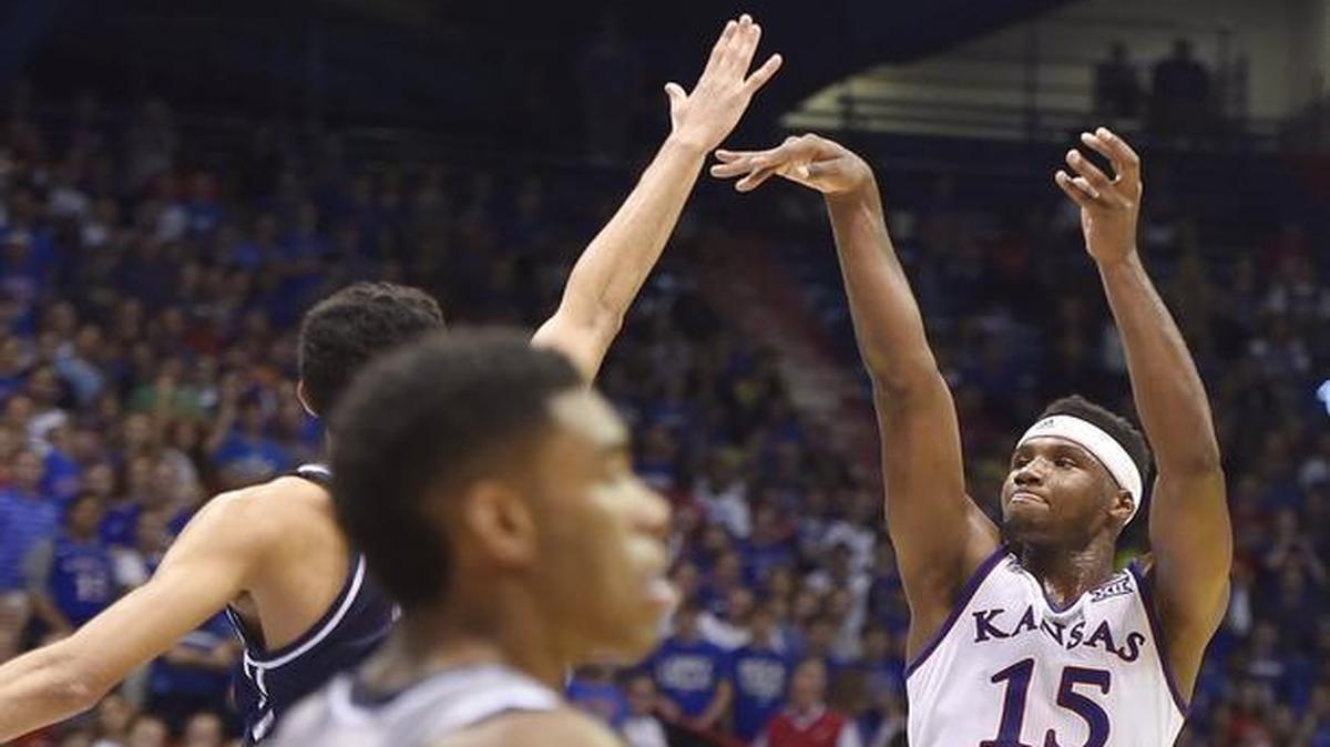 KU's Carlton Bragg lets go of a 3-pointer during the first half of Tuesday night's exhibition game at Allen Fieldhouse. KU beat Washburn 92-74.