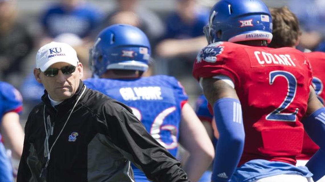 Kansas football coach David Beaty (center) still hasn’t decided whether Montell Cozart (right) or Ryan Willis will be the starting quarterback this season.