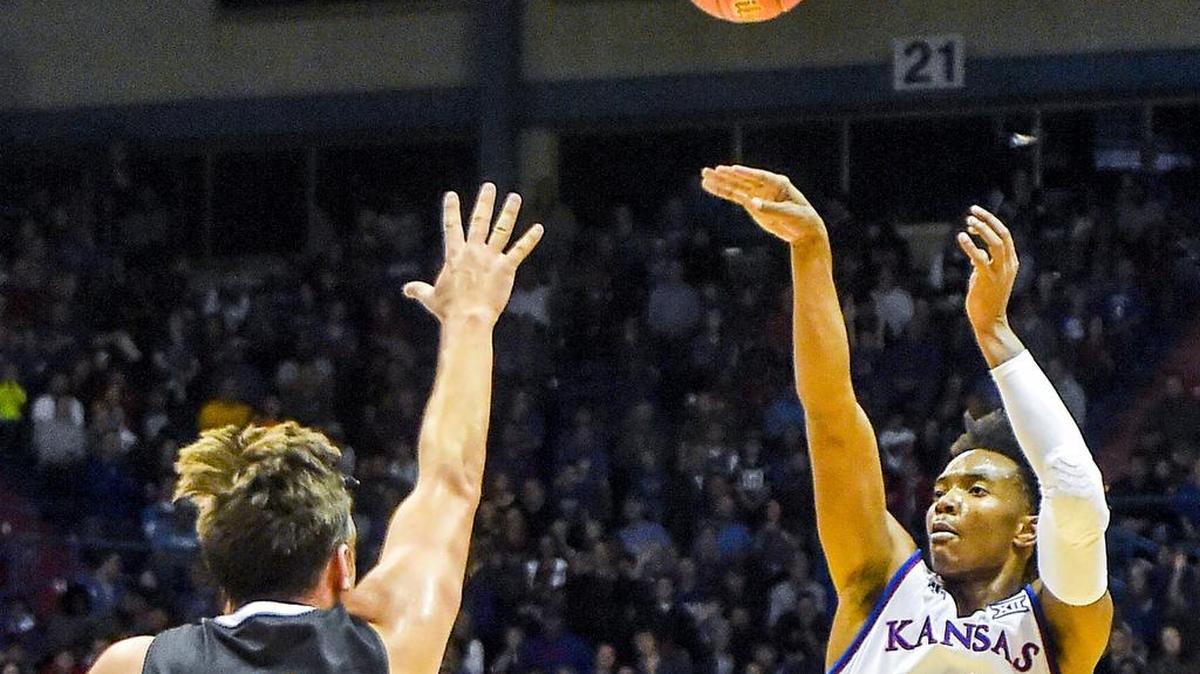 Kansas Jayhawks guard Devonté Graham (right)