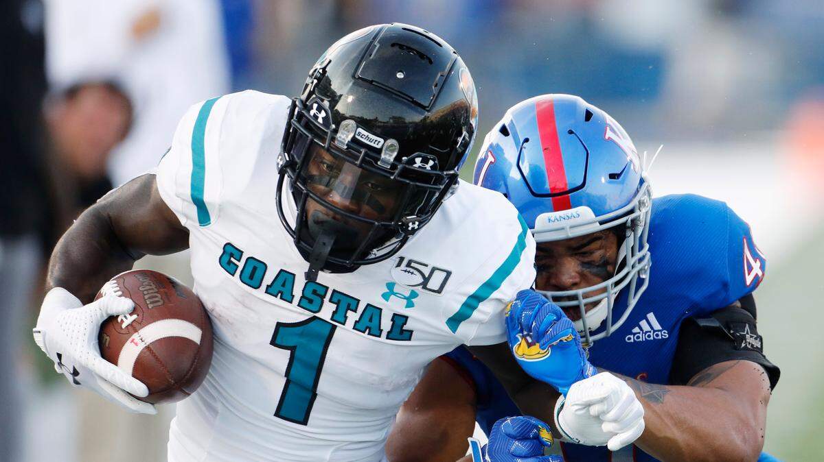 Coastal Carolina running back C.J. Marable (1) attempts to get past Kansas linebacker Dru Prox (40) during a game on Saturday, Sept. 7, 2019 in Lawrence. KU lost to Coastal Carolina, 12-7.