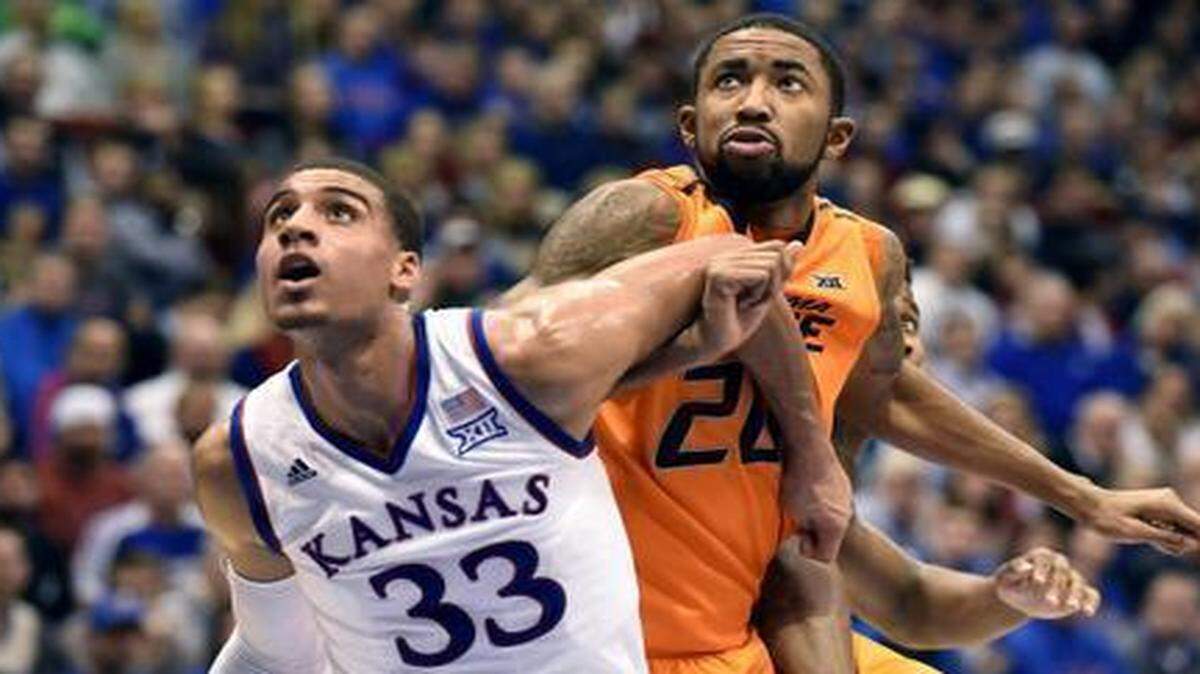 
Kansas’ Landen Lucas blocked out Oklahoma State’s Michael Cobbins during a Jan. 13 KU victory.
