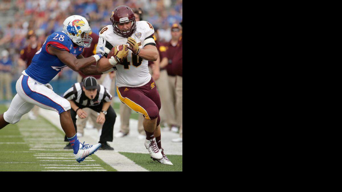 
Central Michigan fullback Joe Bacci (40) was pushed out of bounds by Kansas linebacker Courtney Arnick (28) in the first half Saturday in Lawrence.
