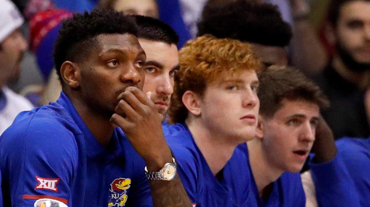 FILE - In this Jan. 14, 2019, file photo, Kansas’ Silvio De Sousa, left, watches from the bench during the first half of a college basketball game against Texas, in Lawrence.